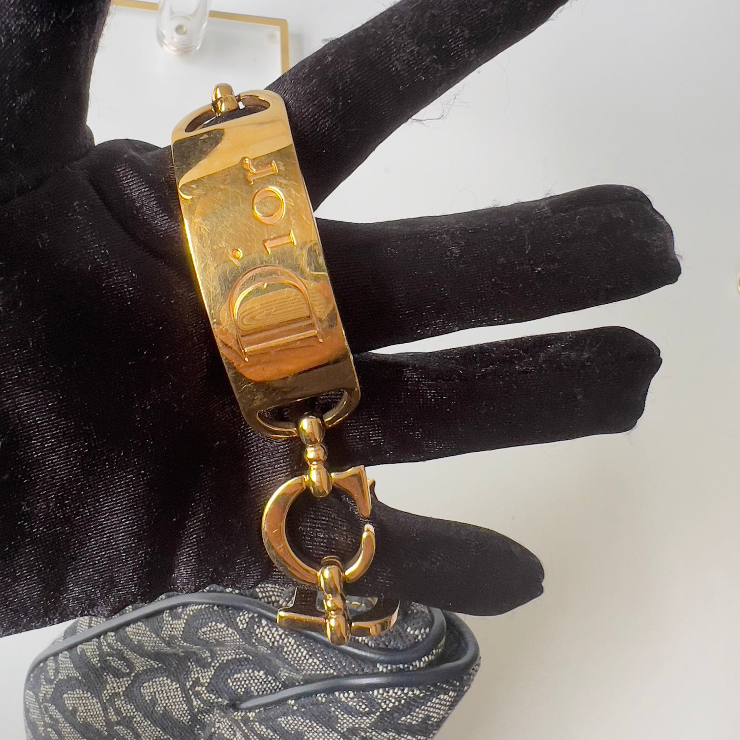 Vintage John Galliano era Dior Diorissimo Mini Saddle Charm Wristlet Bag in Navy Oblique Canvas with Gold-tone hardware.