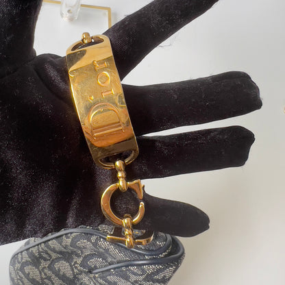 Vintage John Galliano era Dior Diorissimo Mini Saddle Charm Wristlet Bag in Navy Oblique Canvas with Gold-tone hardware.