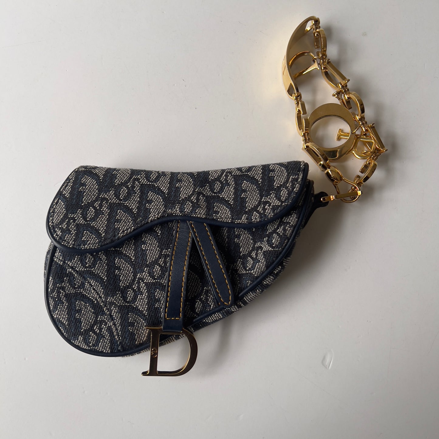 Vintage John Galliano era Dior Diorissimo Mini Saddle Charm Wristlet Bag in Navy Oblique Canvas with Gold-tone hardware.